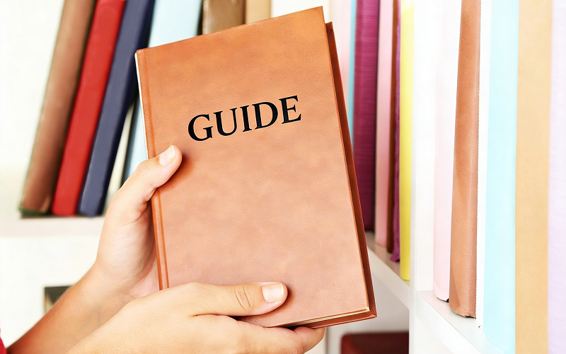 Student picking up an biology study guide.