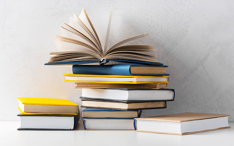 Stack of 2025 IB textbooks for Singapore students' curriculum.